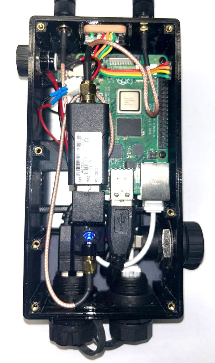Inside a completed Basecamp node: Raspberry Pi 4B, HaLow radio, GPS module, and USB expansion feeding the dual-USB bulkhead in the printed case.